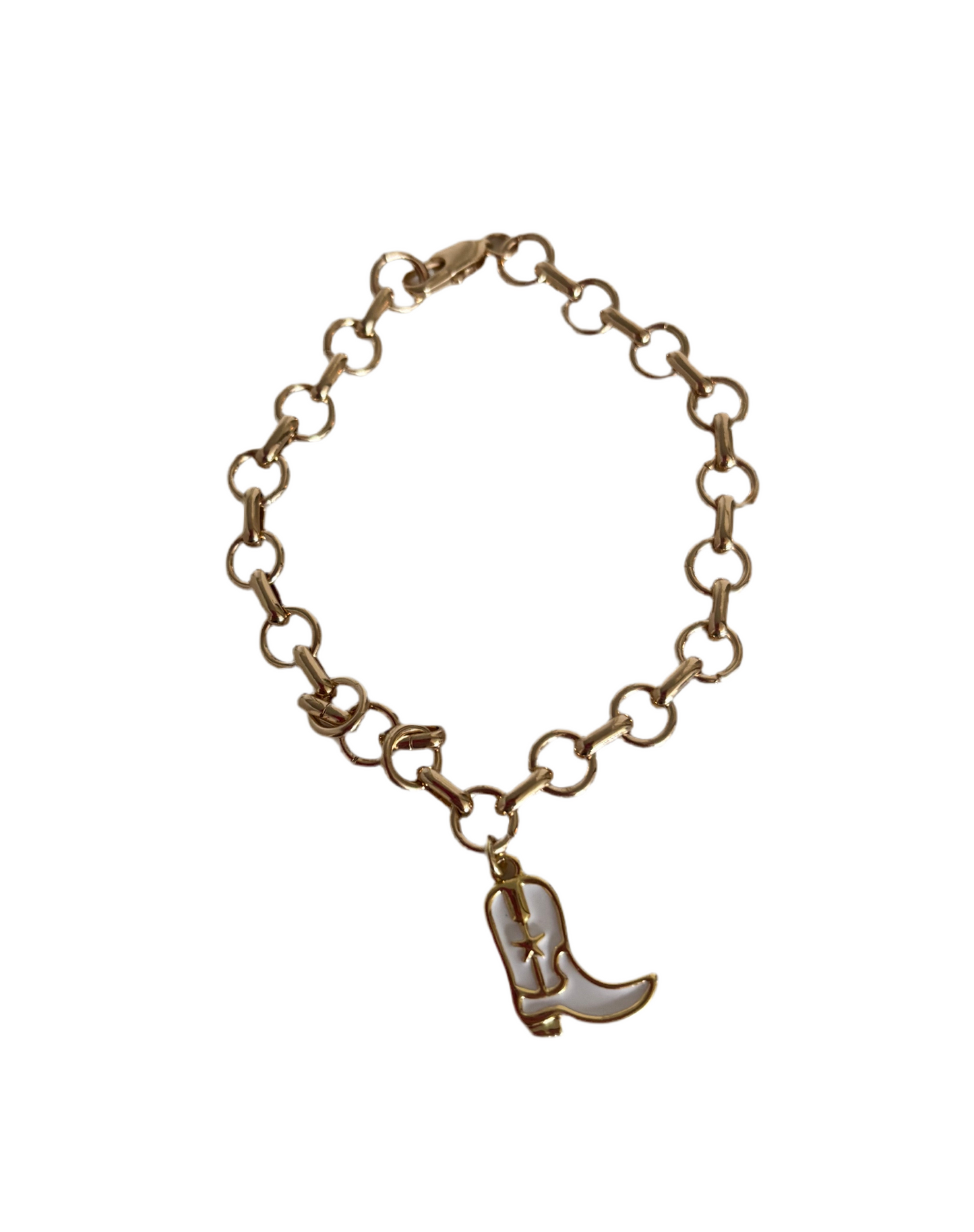 Gold charm bracelet with a white cowboy boot charm on a white background