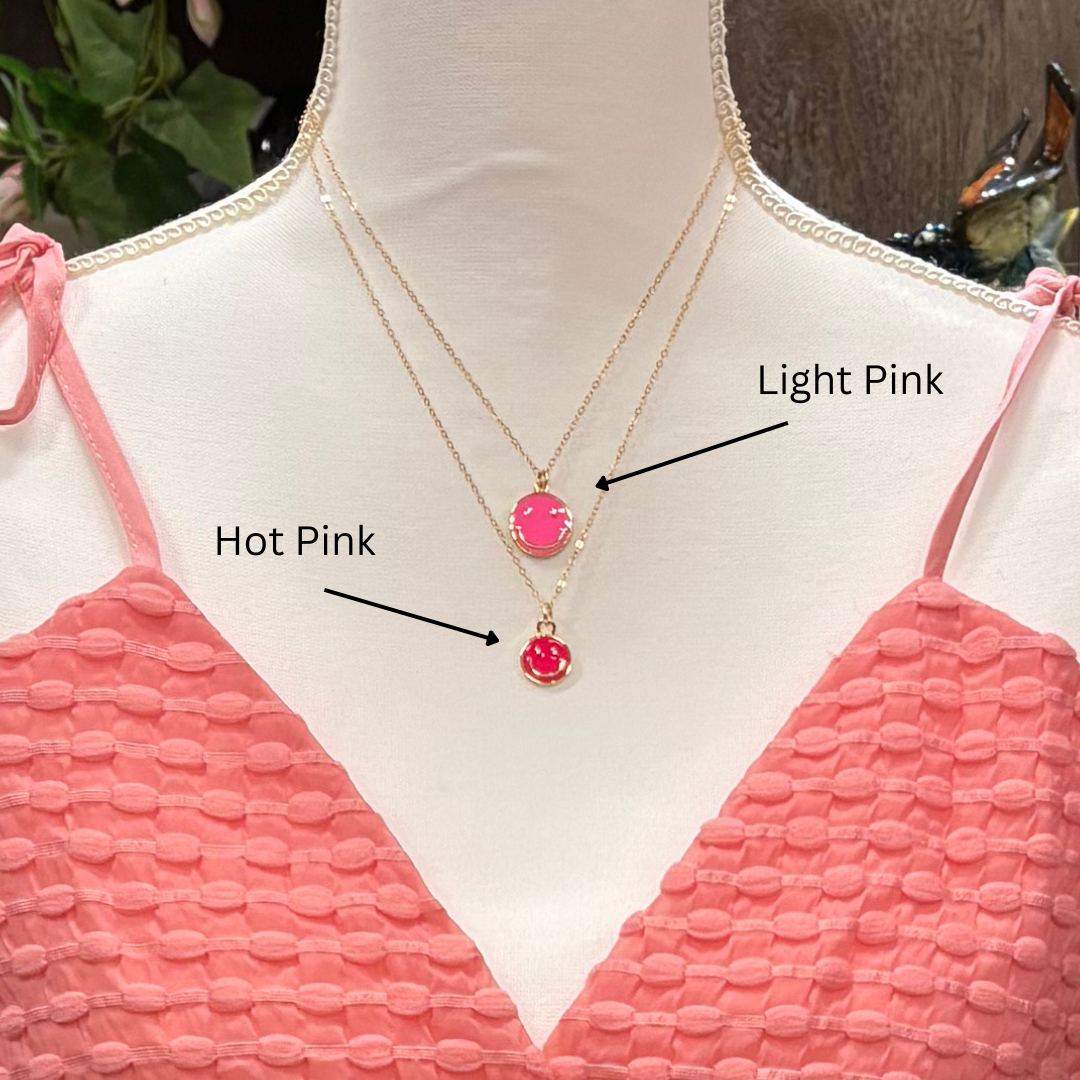 Mannequin wearing a pink top with two necklaces labeled 'Hot Pink' and 'Light Pink'.