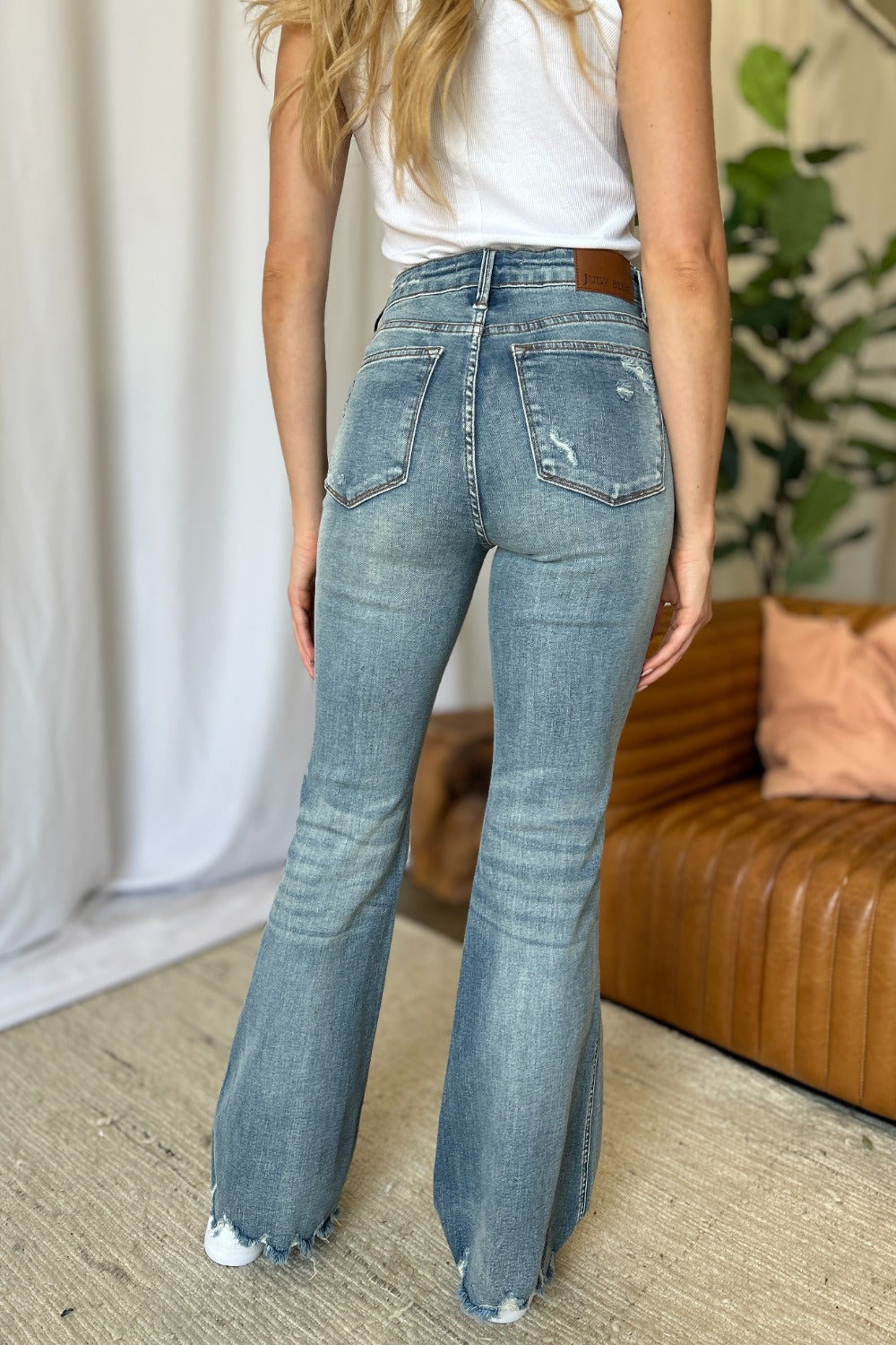 Mid Rise Flare Cut Distressed Jeans in Medium Wash