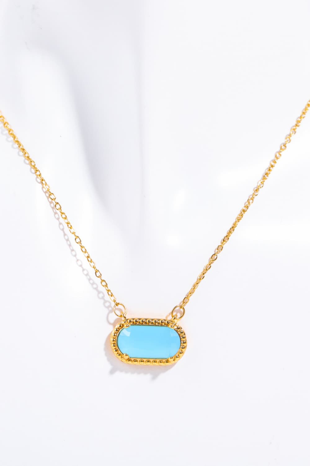 Necklace with a light blue pendant on a white background